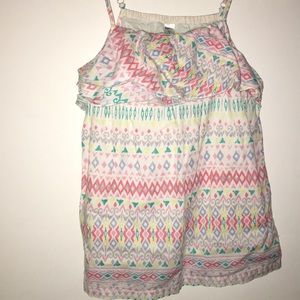 a tanks top with ruffles around the chest